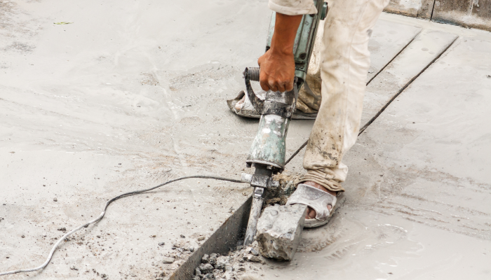 construction-worker-using-jackhammer-drilling-concrete-surface