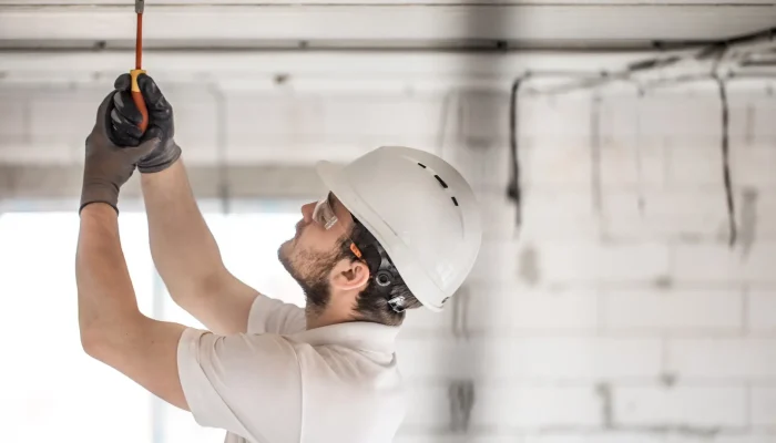 electrician-installer-with-tool-his-hands-working-with-cable-construction-site